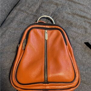 Cognac coloured backpack style purse. Used but in excellent condition.